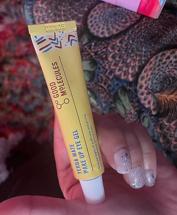 A customer demonstrating the use of the eye cream.