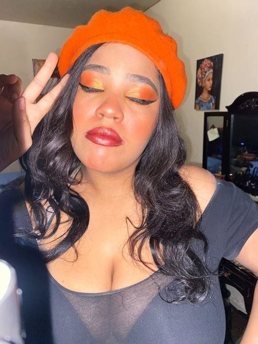 A reviewer's selfie showing off her expertly applied winged eyeliner
