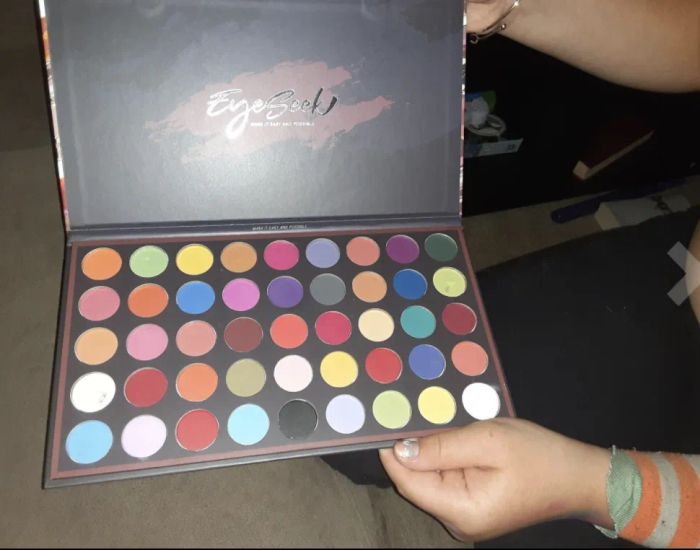 A reviewer holding the palette, showcasing its compact and stylish design.