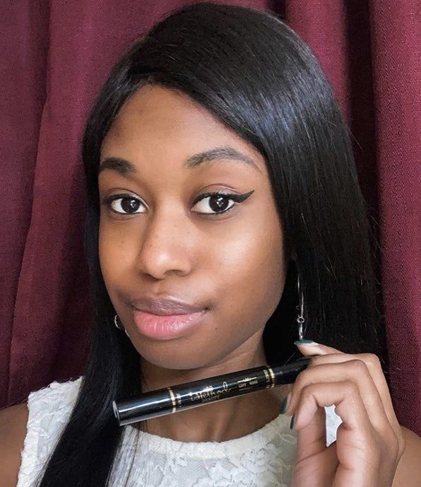 A reviewer’s photo showing black liquid eyeliner while holding the eyeliner pen