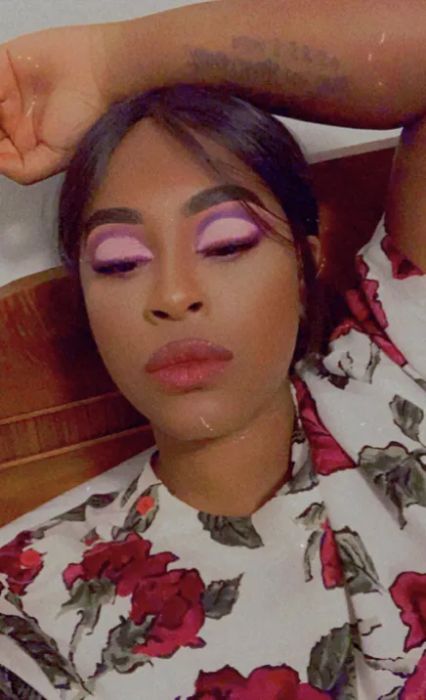 person showcasing a bold eye look using the fruit punch palette