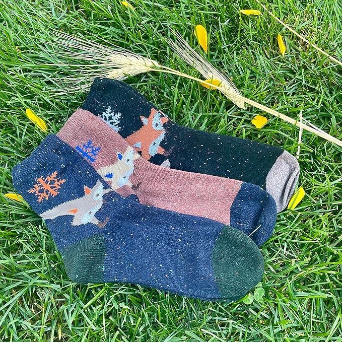 Three pairs of socks adorned with playful animal motifs