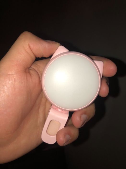 A reviewer holding the off light to display its compact size