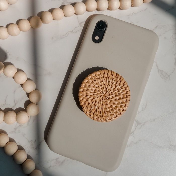 A boho-inspired rattan phone stand paired with a silicone case