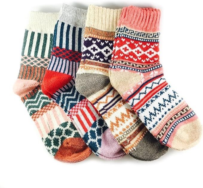 A collection of five vibrant wool socks featuring various geometric designs