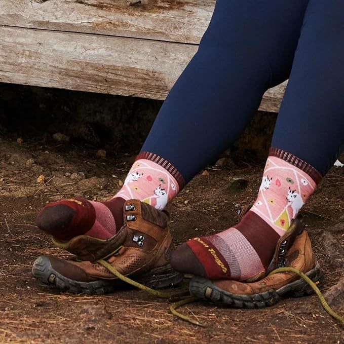 A person's feet clad in vibrant, animal-themed socks