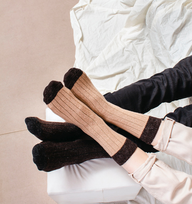 Two individuals enjoying the comfort of cozy socks.