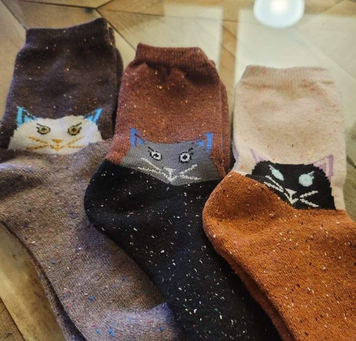 Three pairs of socks featuring adorable cat faces