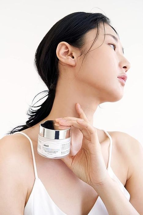 A model showcasing the vitamin E cream jar