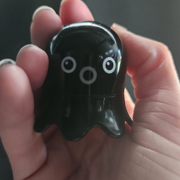 Reviewer holding the octopus-shaped blackhead remover with a grey mouth