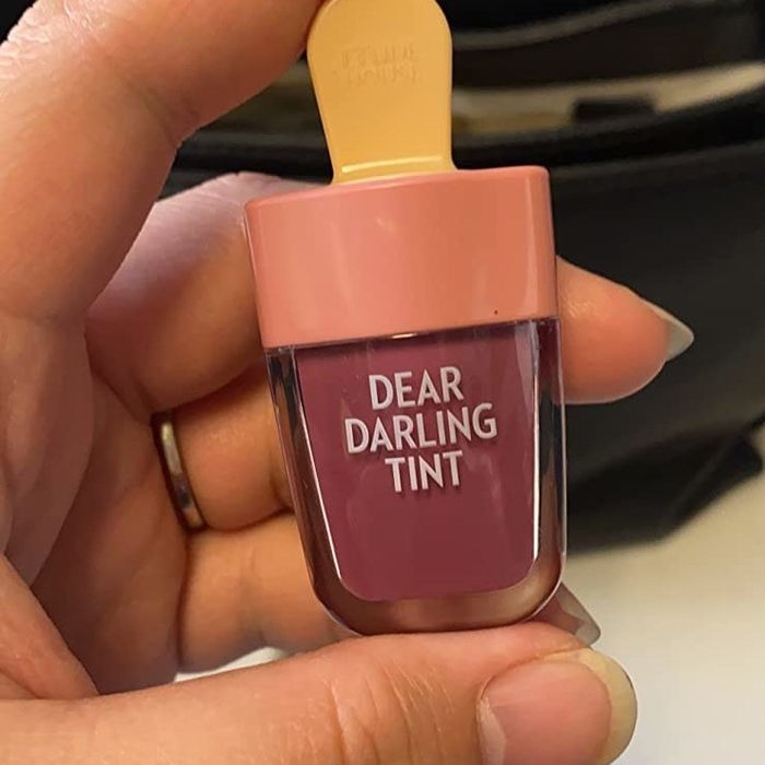 A reviewer showcasing their lip tint application