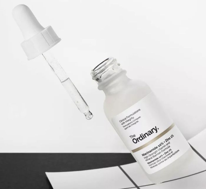 The serum in its packaging next to its dropper