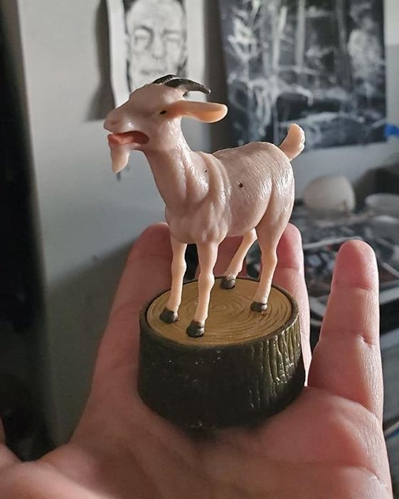 The tiny goat figure resting on the palm of a reviewer’s hand.