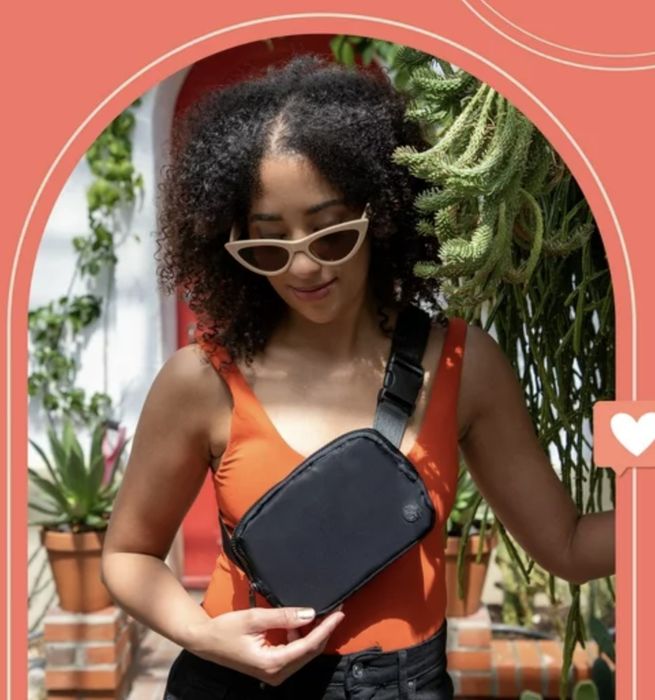 A model showcasing the crossbody bag in sleek black.