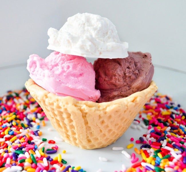 A waffle bowl filled with three different ice cream soaps: chocolate, vanilla, and strawberry