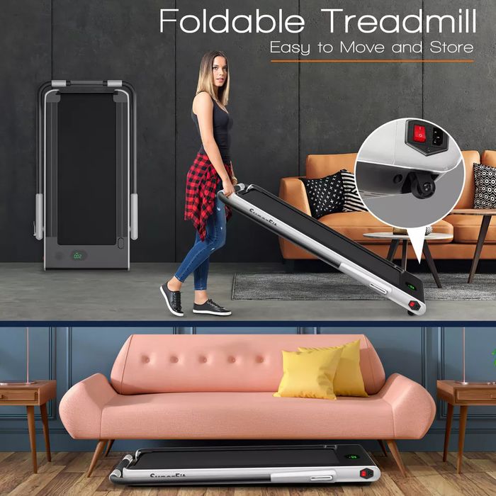 A foldable treadmill is being effortlessly moved by an individual across a living room, demonstrating how easily it stores under a sofa for compact storage