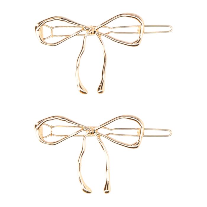 A pair of minimalist gold-tone bow hair clips with a sleek and simple design.