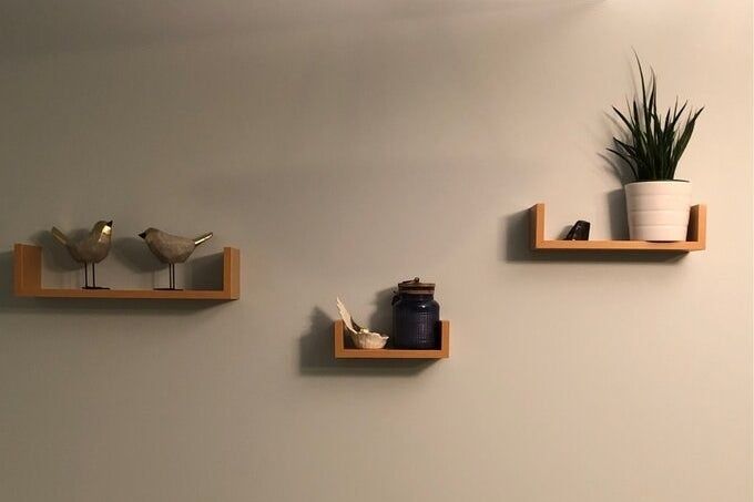 Reviewer image of the shelves mounted on their wall with decorative items displayed
