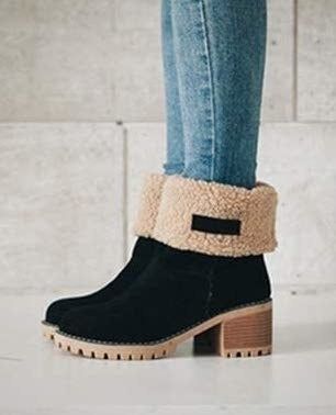 A black suede boot with its top folded over to reveal the fuzzy interior.