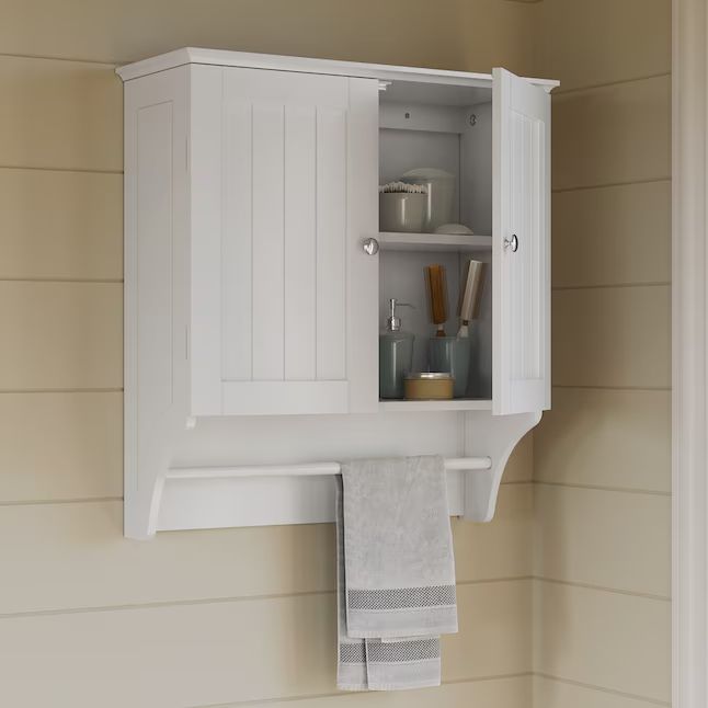 A wall-mounted bathroom cabinet with its doors open, displaying toiletries, and a towel rack beneath holding two neatly folded towels.