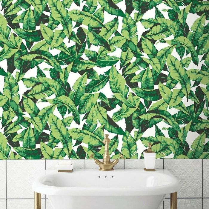 Green botanical peel-and-stick wallpaper applied in a bathroom for a refreshing natural look.