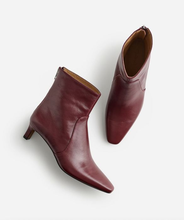 A pair of leather ankle boots with a pointed toe and a modest heel