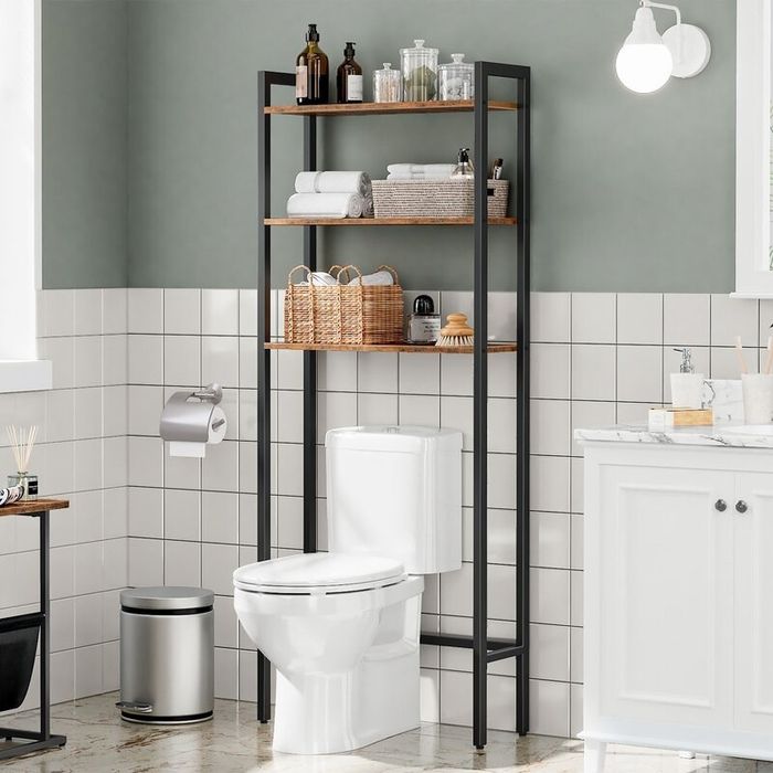 Shelves above a toilet with a few items placed on them.