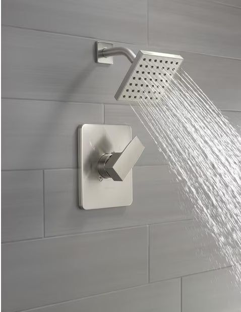 A sleek, modern showerhead delivering a consistent water flow, installed on a beautifully tiled wall.