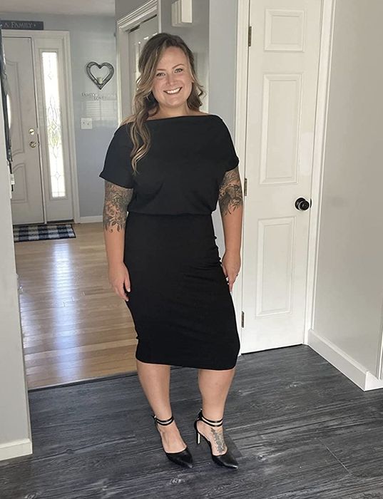 A reviewer sporting a black dress