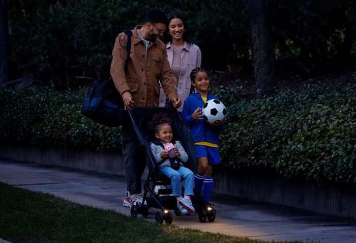 A family enjoying a walk with their stroller.