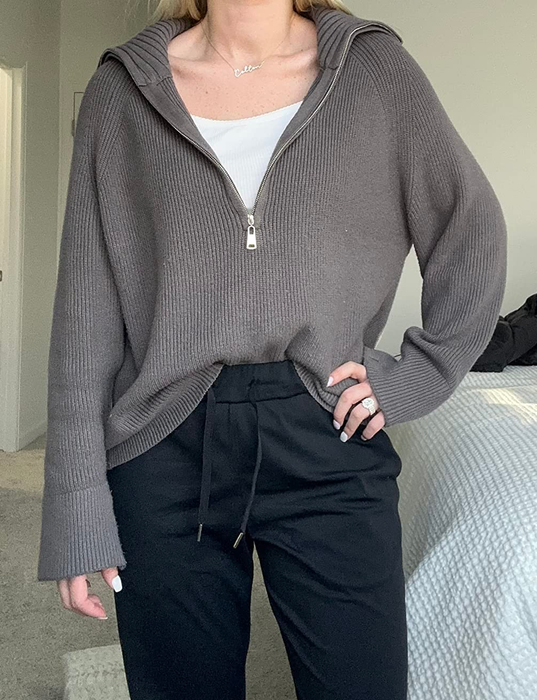 A reviewer is wearing the gray sweater.