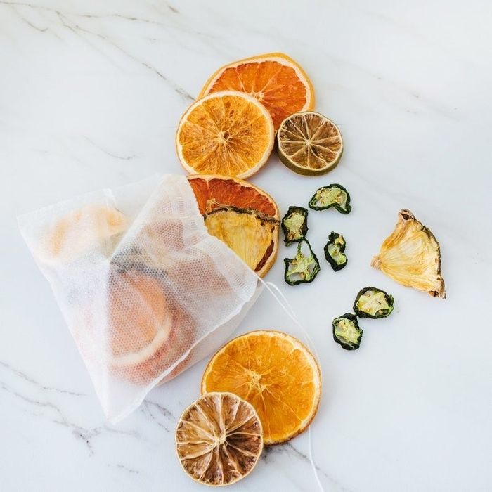 Contents of the mesh bags include dried grapefruits, oranges, jalapeños, pineapples, and limes.