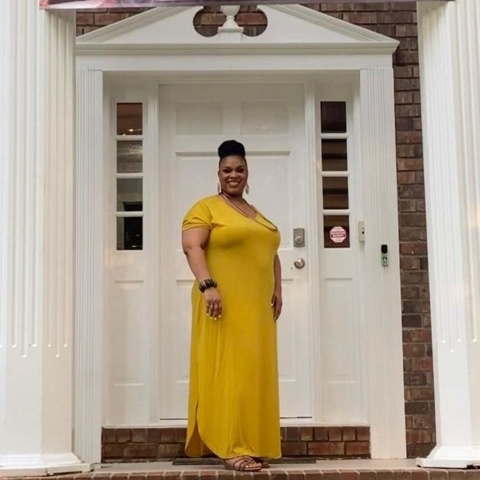 A reviewer wears a mustard-colored dress.