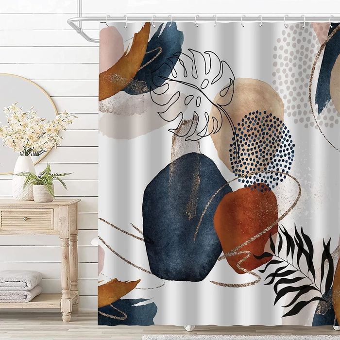 A white shower curtain featuring a colorful abstract print.