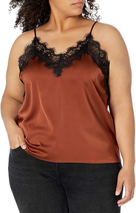 A model sports an orange tank top, accentuated with black lace.