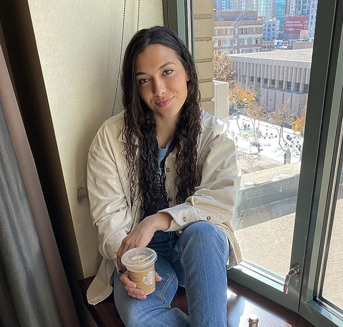 Reviewer showcasing the beige top