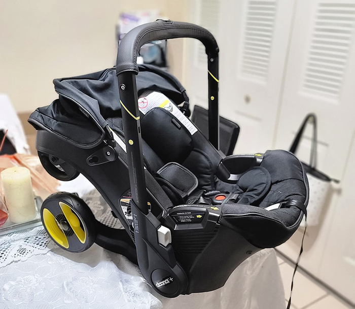 An infant car seat equipped with a wheeled base for added convenience.