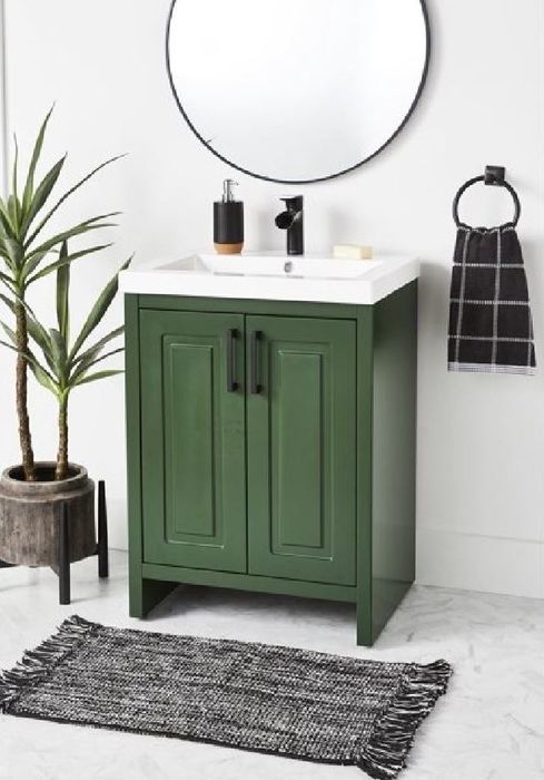 A dark green under-sink bathroom vanity.