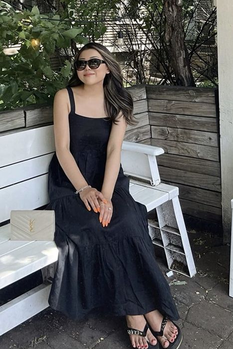 A reviewer wearing the black dress.