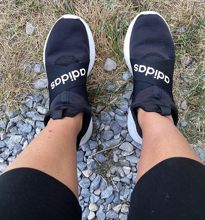 Reviewer wearing black Adidas running shoes