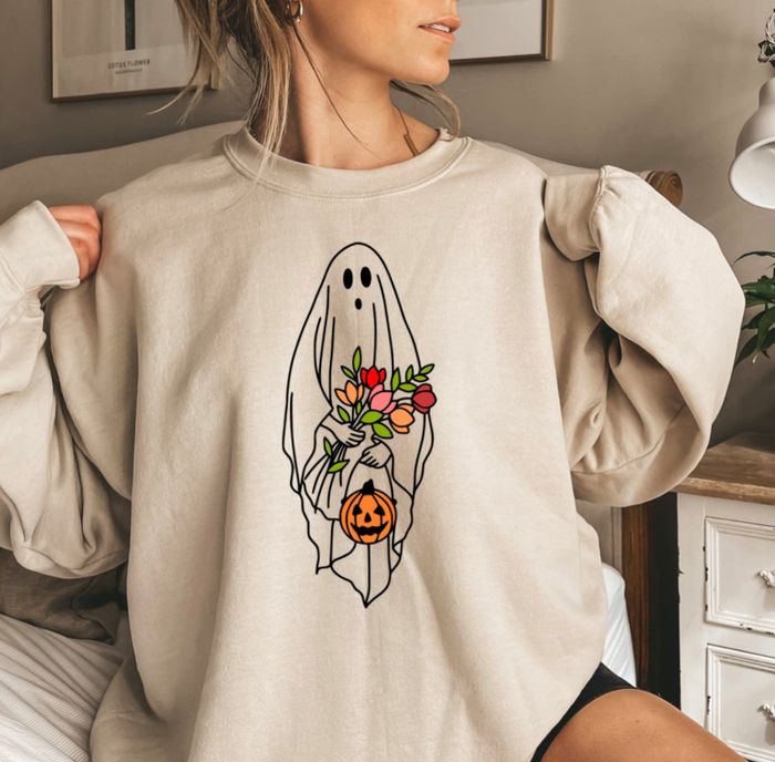 A model is seen wearing a white crewneck, adding a classic touch to their outfit.