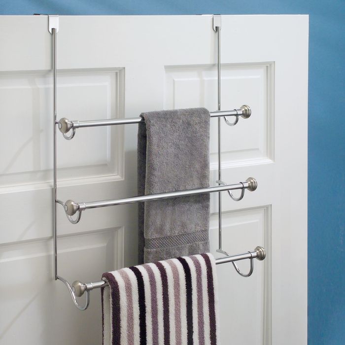 An over-the-shower door towel rack for better organization.