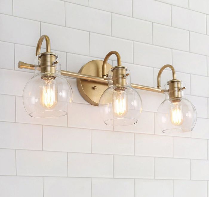 Gold overhead lighting with a gold base.