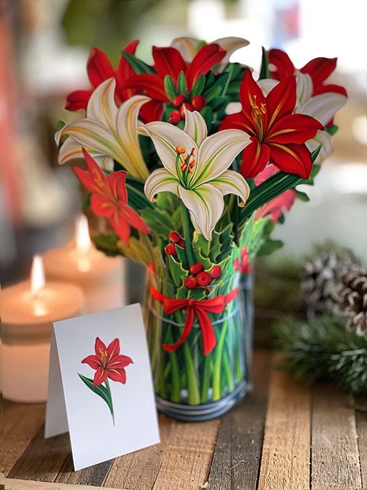 A festive bouquet featuring white and red lilies
