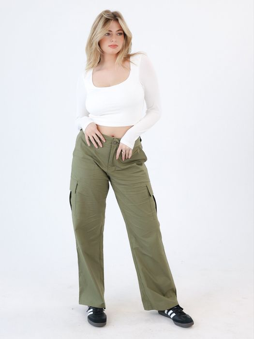 A model is styled in the green cargo pants.