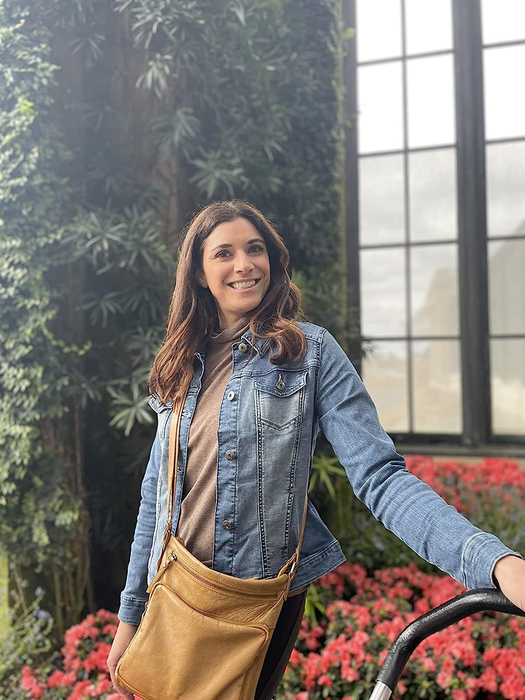 The reviewer combines the blue jean jacket with a brown top for a stylish look.