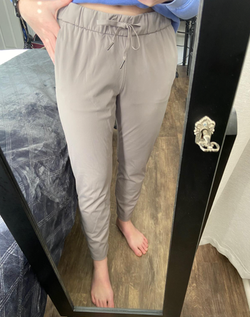 A close-up of the reviewer in the gray version highlights the elastic waist.