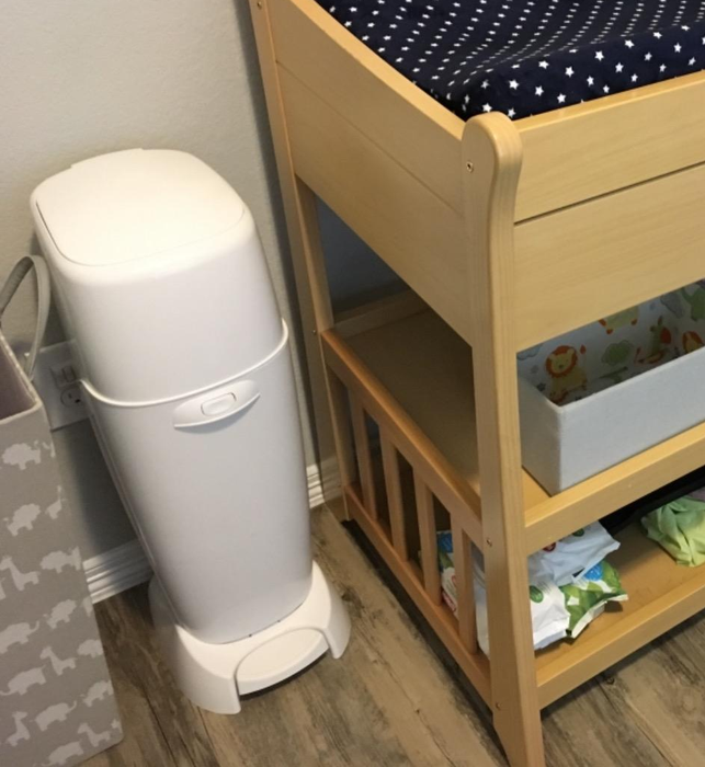 A sleek white diaper pail designed for convenience and odor control.