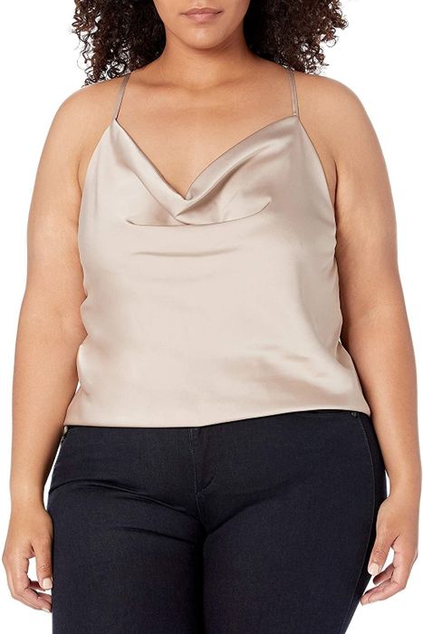 A model dons a beige cowl neck top, exuding effortless style.