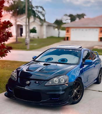 A custom car with playful facial features, resembling a character from a popular animated film.
